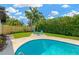Inviting backyard with a pool and comfortable seating offers a perfect spot for relaxation and entertainment at 11361 88Th Ave, Seminole, FL 33772
