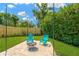 Cozy backyard setup with a fire pit, seating, and lush greenery, perfect for outdoor relaxation and gatherings at 11361 88Th Ave, Seminole, FL 33772