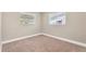 Cozy bedroom featuring carpet, two windows letting in natural light, and baseboard trim at 11361 88Th Ave, Seminole, FL 33772