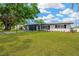 Charming single-story home with a well-manicured lawn, dark garage door, and inviting curb appeal at 11361 88Th Ave, Seminole, FL 33772