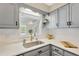 Bright kitchen features white countertops, subway tile backsplash and stainless steel sink at 11361 88Th Ave, Seminole, FL 33772