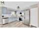 Charming kitchen featuring stylish blue cabinetry, modern stainless steel appliances, and bright countertops at 11361 88Th Ave, Seminole, FL 33772