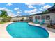 Beautiful pool area with clear blue water, surrounded by ample patio space and a well-maintained lawn at 11361 88Th Ave, Seminole, FL 33772
