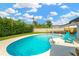Backyard pool with comfortable seating, offering a relaxing space to enjoy the outdoors at 11361 88Th Ave, Seminole, FL 33772