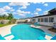 Beautiful pool with clear blue water and a white concrete deck with comfortable blue chairs for relaxing at 11361 88Th Ave, Seminole, FL 33772