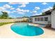Private pool with a sunny patio and a white fence provide a relaxing outdoor escape at 11361 88Th Ave, Seminole, FL 33772