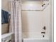 Bathroom shower and tub featuring tile and a shower curtain at 11602 Crowned Sparrow Ln, Tampa, FL 33626
