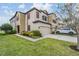 Attractive two-story townhome with two-car garage, lush lawn and colorful landscaping at 11602 Crowned Sparrow Ln, Tampa, FL 33626