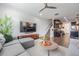 Open concept living room with dark cabinets and a large flat screen television at 11602 Crowned Sparrow Ln, Tampa, FL 33626
