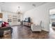 Living room featuring hardwood floors, flat screen tv, and modern lighting fixture at 11602 Crowned Sparrow Ln, Tampa, FL 33626
