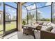 A screened patio with outdoor seating at 11602 Crowned Sparrow Ln, Tampa, FL 33626