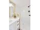 Bright bathroom features a white vanity, a white tile shower, and modern matte black fixtures at 12006 Glenshire Dr, Riverview, FL 33579