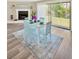 Cozy dining area with a modern table set, a fireplace, and sliding doors to the outdoor space at 12006 Glenshire Dr, Riverview, FL 33579
