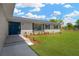 Charming home exterior with a blue front door and landscaped garden at 12006 Glenshire Dr, Riverview, FL 33579