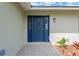 Inviting entryway with a stylish blue front door, sidelights, and decorative landscaping at 12006 Glenshire Dr, Riverview, FL 33579