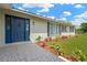 Charming home exterior with a blue front door and landscaped garden at 12006 Glenshire Dr, Riverview, FL 33579
