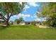 Ranch style home featuring a well-maintained lawn, mature trees, and a welcoming driveway at 12006 Glenshire Dr, Riverview, FL 33579