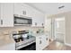 Modern kitchen featuring sleek white cabinets, stainless steel appliances, and quartz countertops at 12006 Glenshire Dr, Riverview, FL 33579