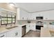 Modern kitchen featuring sleek white cabinets, stainless steel appliances, and quartz countertops at 12006 Glenshire Dr, Riverview, FL 33579