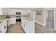 Bright kitchen featuring stainless steel appliances, white cabinetry, and a center island with quartz countertop at 12006 Glenshire Dr, Riverview, FL 33579