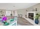 Living room with fireplace and wood floors, featuring ample seating and an open layout to the dining area at 12006 Glenshire Dr, Riverview, FL 33579