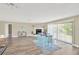 Open-concept living space connecting a dining area with a cozy fireplace and sliding door access at 12006 Glenshire Dr, Riverview, FL 33579