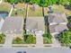 Aerial view of a neighborhood with manicured lawns, mature trees, and well-maintained homes at 1218 Halapa Way, Trinity, FL 34655
