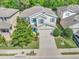 Charming two-story home with a well-manicured lawn, a wide driveway, and blue shutters at 1218 Halapa Way, Trinity, FL 34655