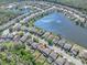 Aerial view of lakefront community highlighting the home's location near waterfront and community amenities at 1218 Halapa Way, Trinity, FL 34655