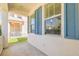 The balcony with blue shutters overlooks the front yard at 1218 Halapa Way, Trinity, FL 34655
