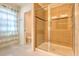 Bright bathroom featuring a glass shower with tile surround and a toilet in a separate alcove at 1218 Halapa Way, Trinity, FL 34655
