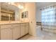 Bathroom features a double vanity, tiled shower, soaking tub, and natural light at 1218 Halapa Way, Trinity, FL 34655