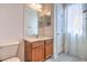 Bright bathroom with a wooden vanity, large mirror, and a window that provides natural light at 1218 Halapa Way, Trinity, FL 34655