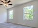 Bedroom with neutral walls and modern flooring has large windows at 1218 Halapa Way, Trinity, FL 34655