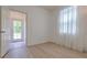 Bedroom with natural light has luxury vinyl plank flooring and access to the backyard at 1218 Halapa Way, Trinity, FL 34655