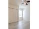 Neutral bedroom with wood-look flooring, ceiling fan, and closet for efficient storage at 1218 Halapa Way, Trinity, FL 34655