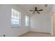 Bright bedroom featuring dual windows and a classic ceiling fan at 1218 Halapa Way, Trinity, FL 34655