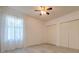 Bright bedroom with wood-look flooring, ceiling fan, closet and natural light at 1218 Halapa Way, Trinity, FL 34655