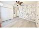 Light and airy bedroom featuring a ceiling fan, painted accent wall, and spacious closet at 1218 Halapa Way, Trinity, FL 34655