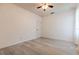 Neutral bedroom with wood-look floors, ceiling fan and lots of natural light at 1218 Halapa Way, Trinity, FL 34655