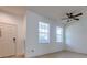 Entryway with wood-look flooring, two windows and a white front door at 1218 Halapa Way, Trinity, FL 34655
