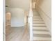Spacious entryway featuring pristine white walls, light plank flooring, and a staircase leading to the second floor at 1218 Halapa Way, Trinity, FL 34655