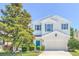 Charming two-story home featuring manicured landscaping, attached two-car garage, and vibrant blue shutters at 1218 Halapa Way, Trinity, FL 34655