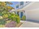 Charming home featuring manicured landscaping, attached two-car garage, and vibrant blue front door at 1218 Halapa Way, Trinity, FL 34655