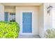 Stylish six-panel front door with modern hardware and a vibrant blue finish is secure and inviting at 1218 Halapa Way, Trinity, FL 34655