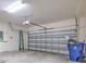 A spacious two-car garage featuring a roll-up door, providing ample parking and storage space at 1218 Halapa Way, Trinity, FL 34655
