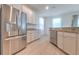 Spacious kitchen features stainless steel appliances, granite counters, and white cabinets at 1218 Halapa Way, Trinity, FL 34655