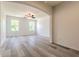 Spacious living room filled with natural light boasts wood-look floors and archway at 1218 Halapa Way, Trinity, FL 34655