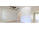 Bright living room with plank flooring, a ceiling fan, and an archway leading to other living spaces at 1218 Halapa Way, Trinity, FL 34655