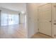 Living room with sliding glass doors to backyard and modern wood-look flooring at 1218 Halapa Way, Trinity, FL 34655